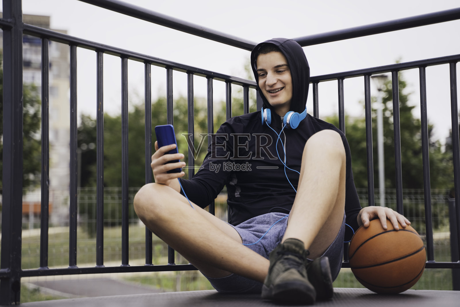 听音乐的少年。使用智能手机、手机。副本的空间。照片摄影图片