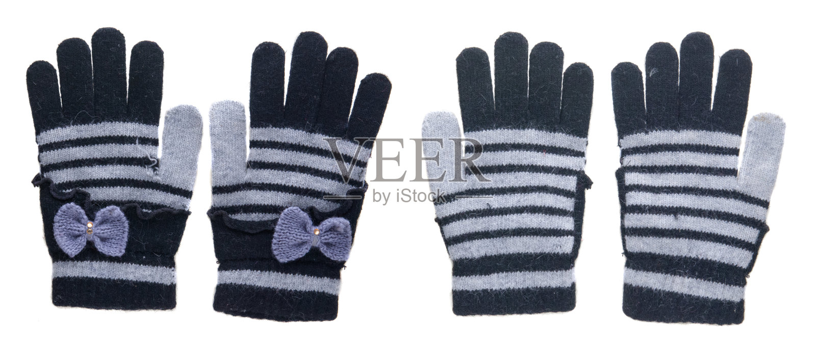 针织手套。手套孤立在白色背景上。手套俯视图。黑色和灰色带蝴蝶结的手套。照片摄影图片