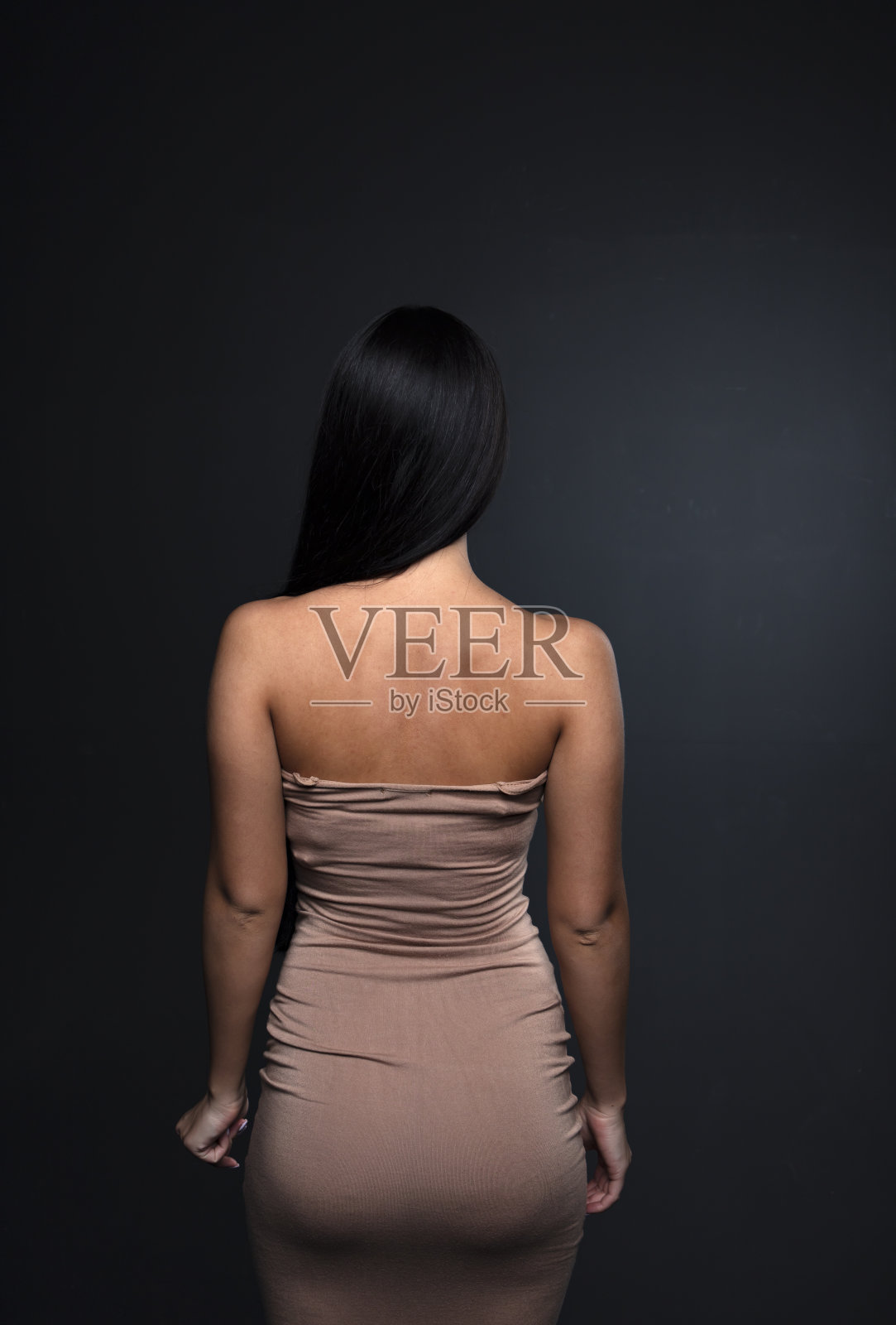 画室里一个年轻女子的肖像，背景是黑色的照片摄影图片