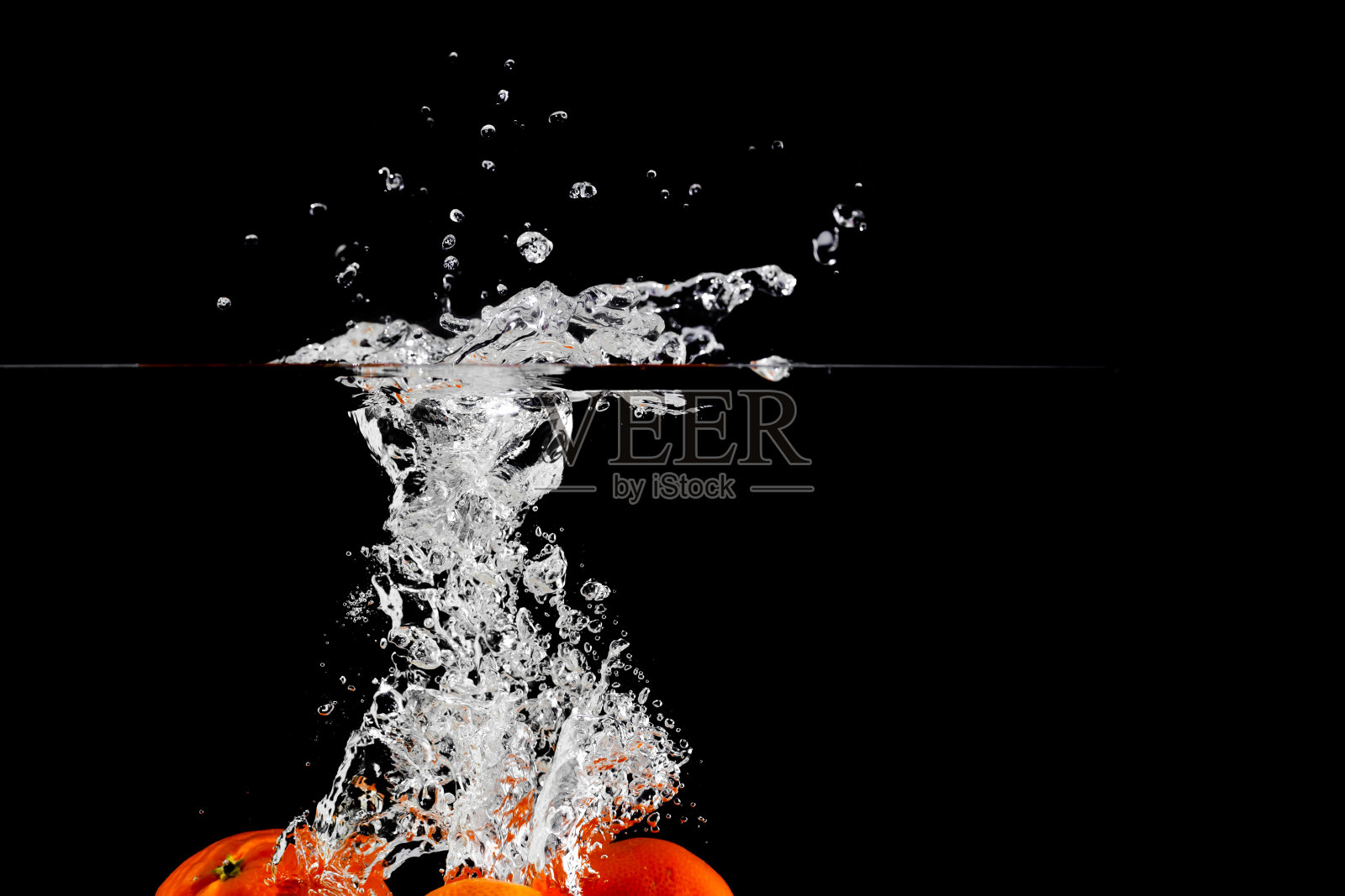 橘子落入水中，置于文字下，黑色背景，孤立照片摄影图片