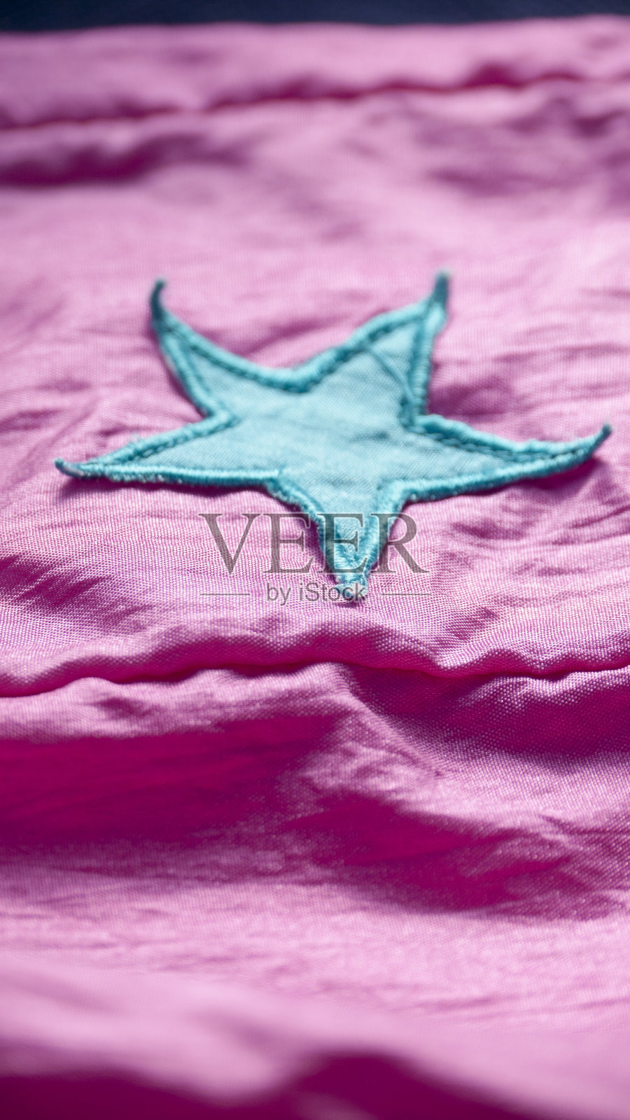 蓝色的星星缝制成粉红色的布料照片摄影图片