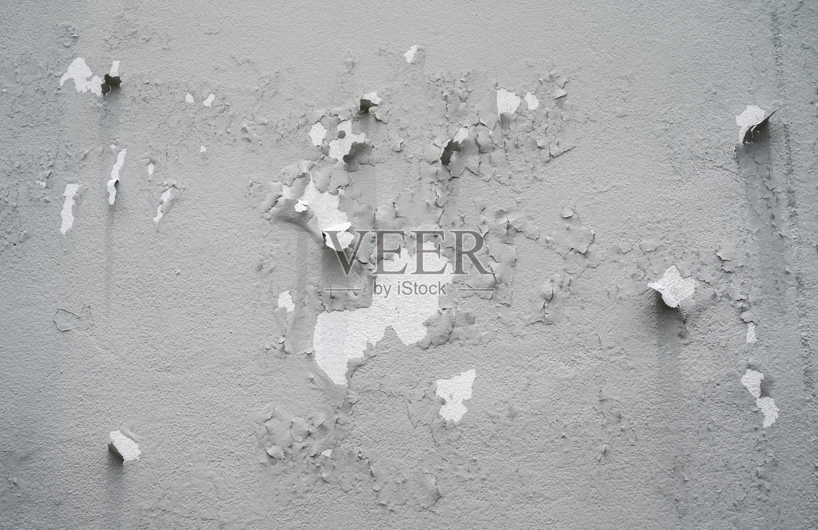 灰色混凝土墙面油漆剥落。照片摄影图片