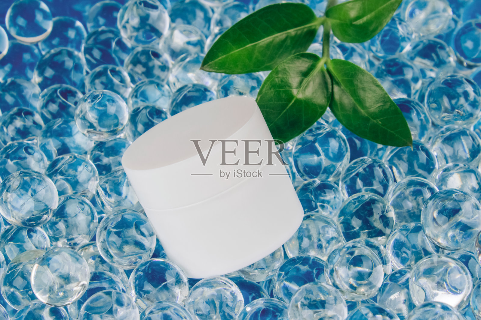 自然身体或面霜的模型图像在浅蓝色的背景与水凝胶球。天然有机草本化妆品概念。时尚的静物创作与复制空间照片摄影图片