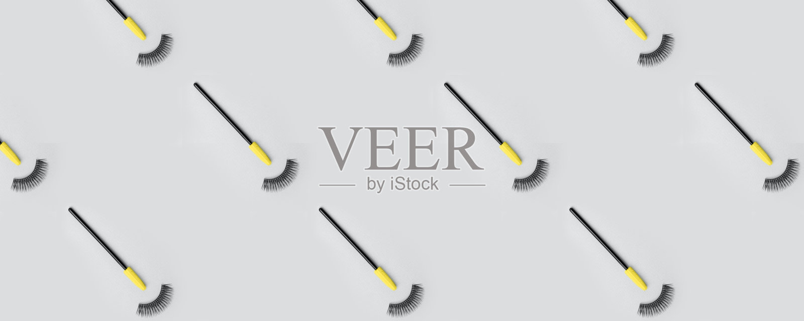 设置为睫毛延伸在时尚的灰色背景。假睫毛、睫毛刷、时尚无缝图案概念、化妆彩妆。横幅网站，标题照片摄影图片