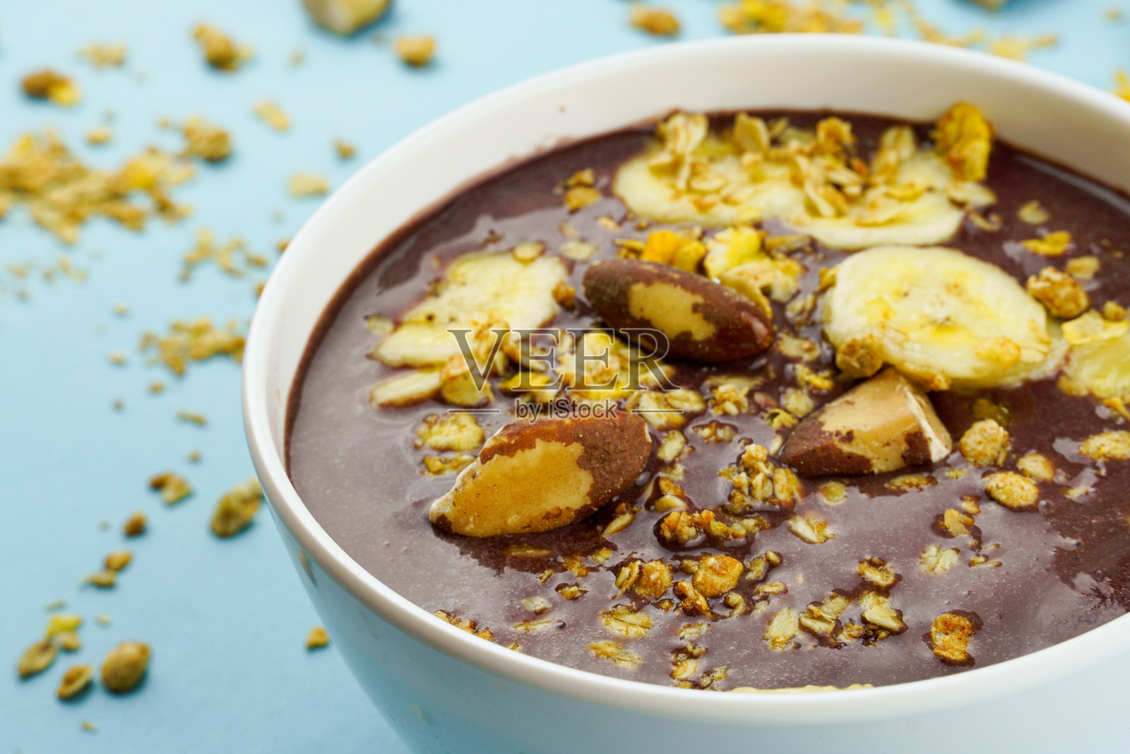 巴西açai在一个白色的碗与香蕉，格兰诺拉麦片和栗子照片摄影图片