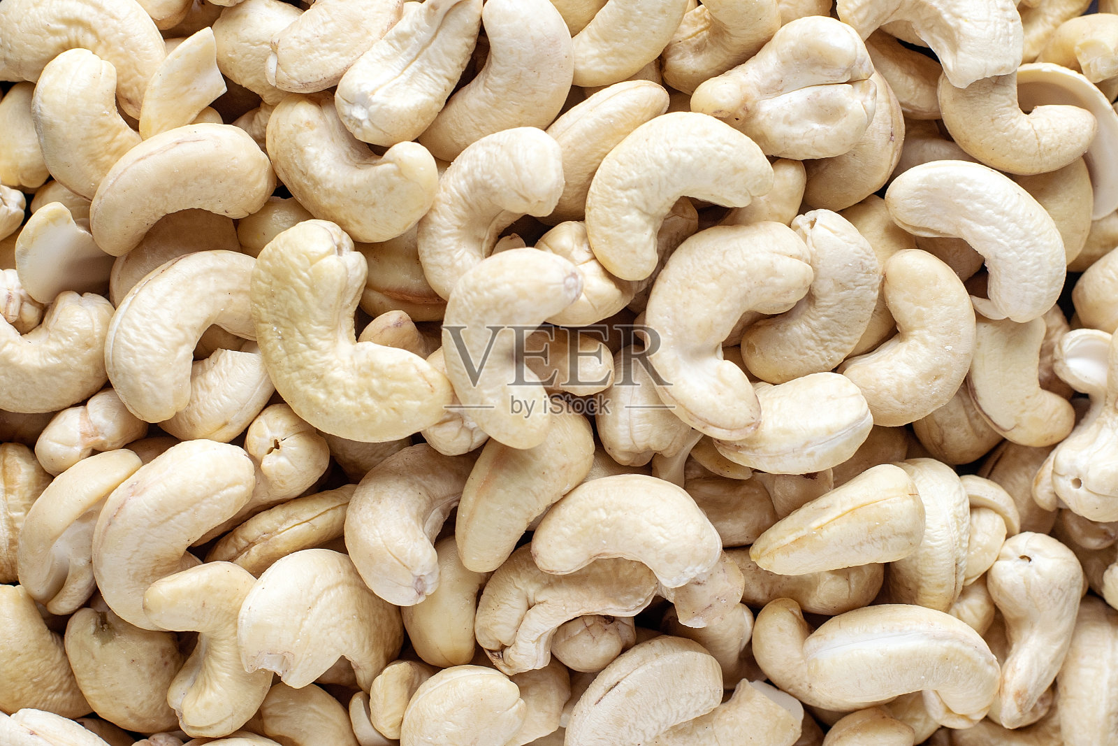 近距离看腰果。背景纹理。照片摄影图片