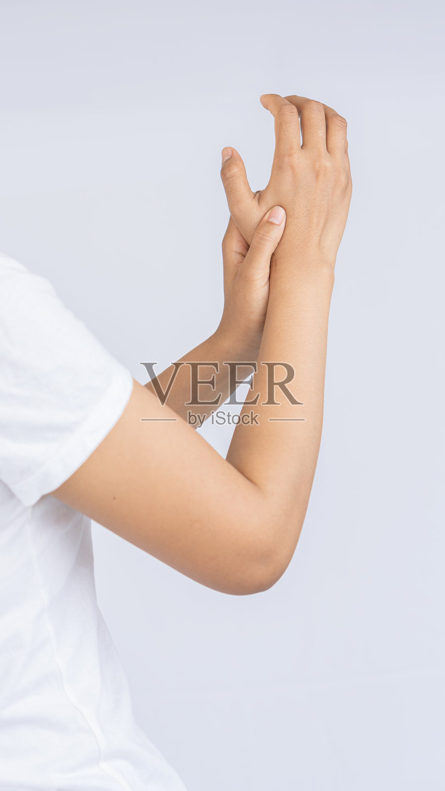 年轻女子手腕疼痛站在白色的背景上，医学概念。照片摄影图片