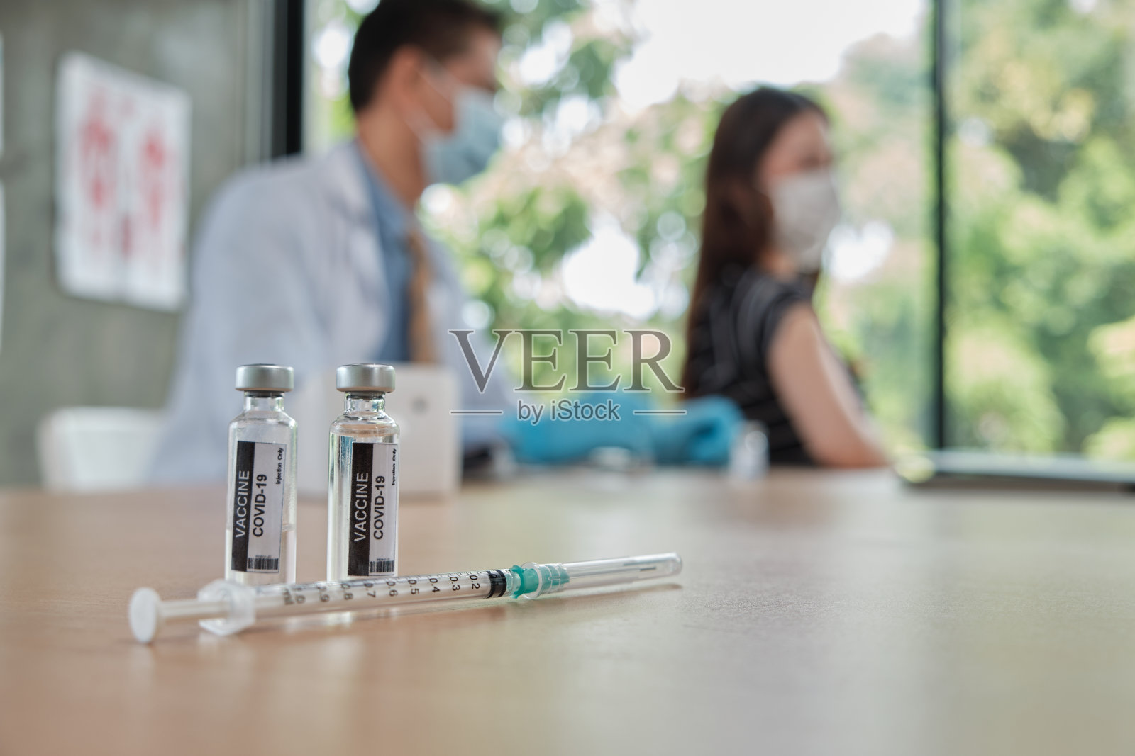 男医生为亚洲妇女接种covid - 19疫苗。照片摄影图片