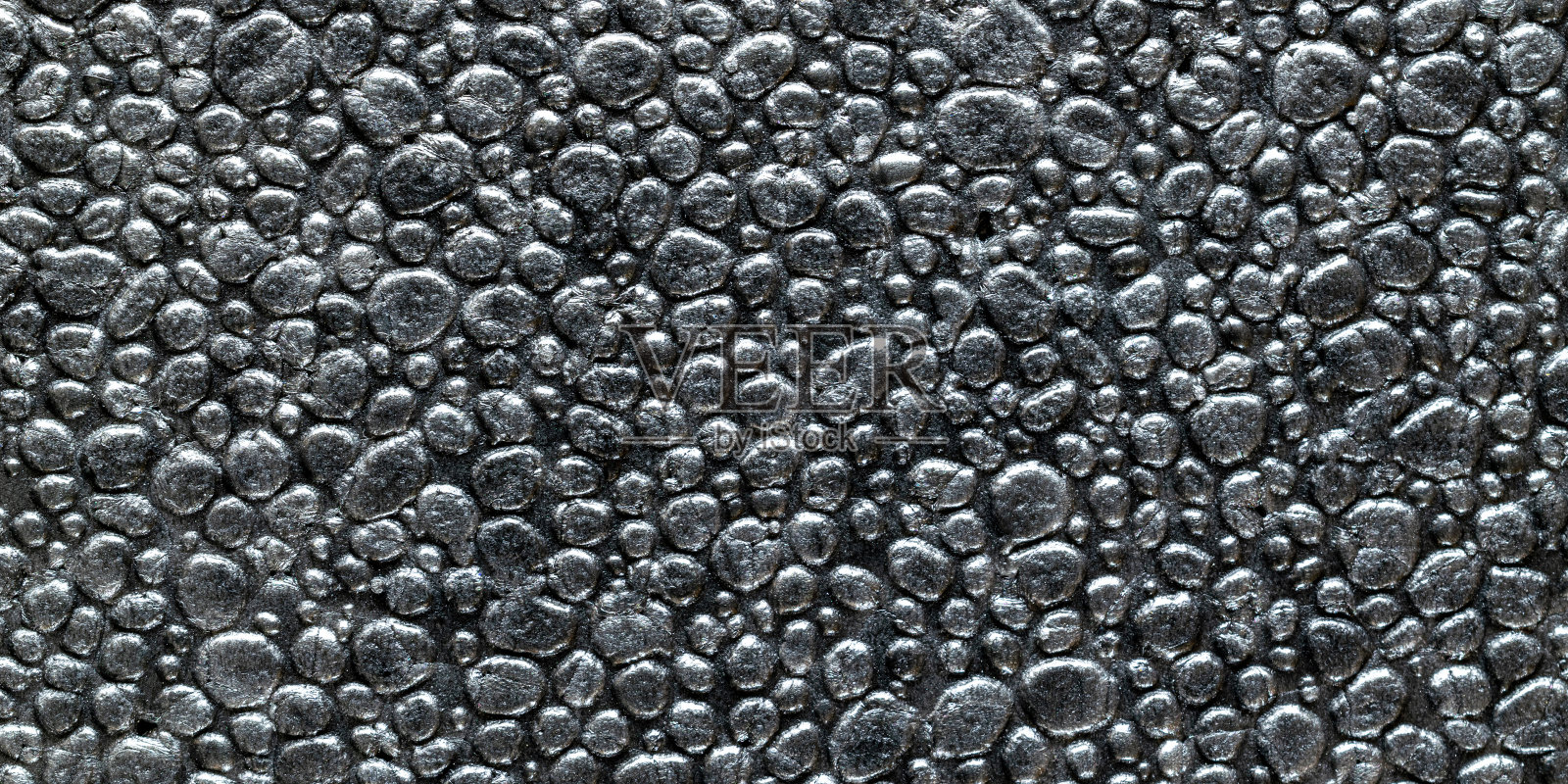 黑色谷物背景。灰墙板背景。灰色泡沫塑料泡沫纹理或白色塑料聚苯乙烯图案。照片摄影图片