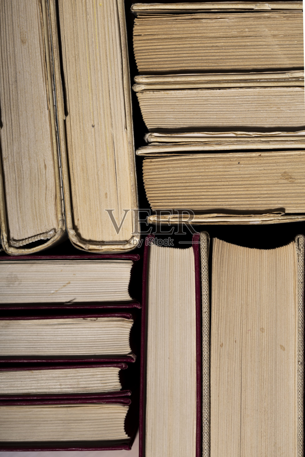 各种书籍堆在木制的背景上照片摄影图片