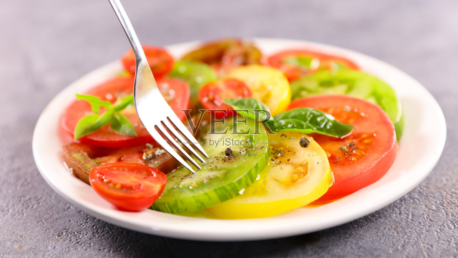 番茄沙拉配橄榄油和罗勒照片摄影图片