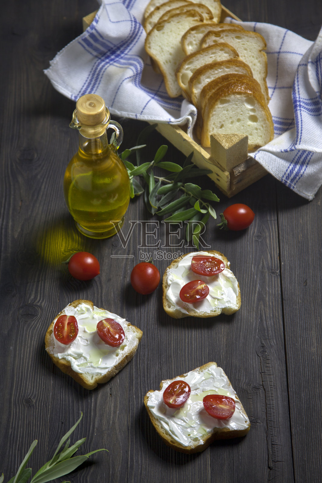 切片面包装在盒子里，配上番茄和奶油芝士，放在木桌上照片摄影图片