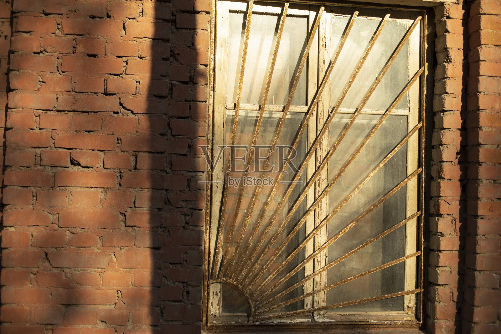 窗户在铁栏杆后面。旧房子的窗户。照片摄影图片