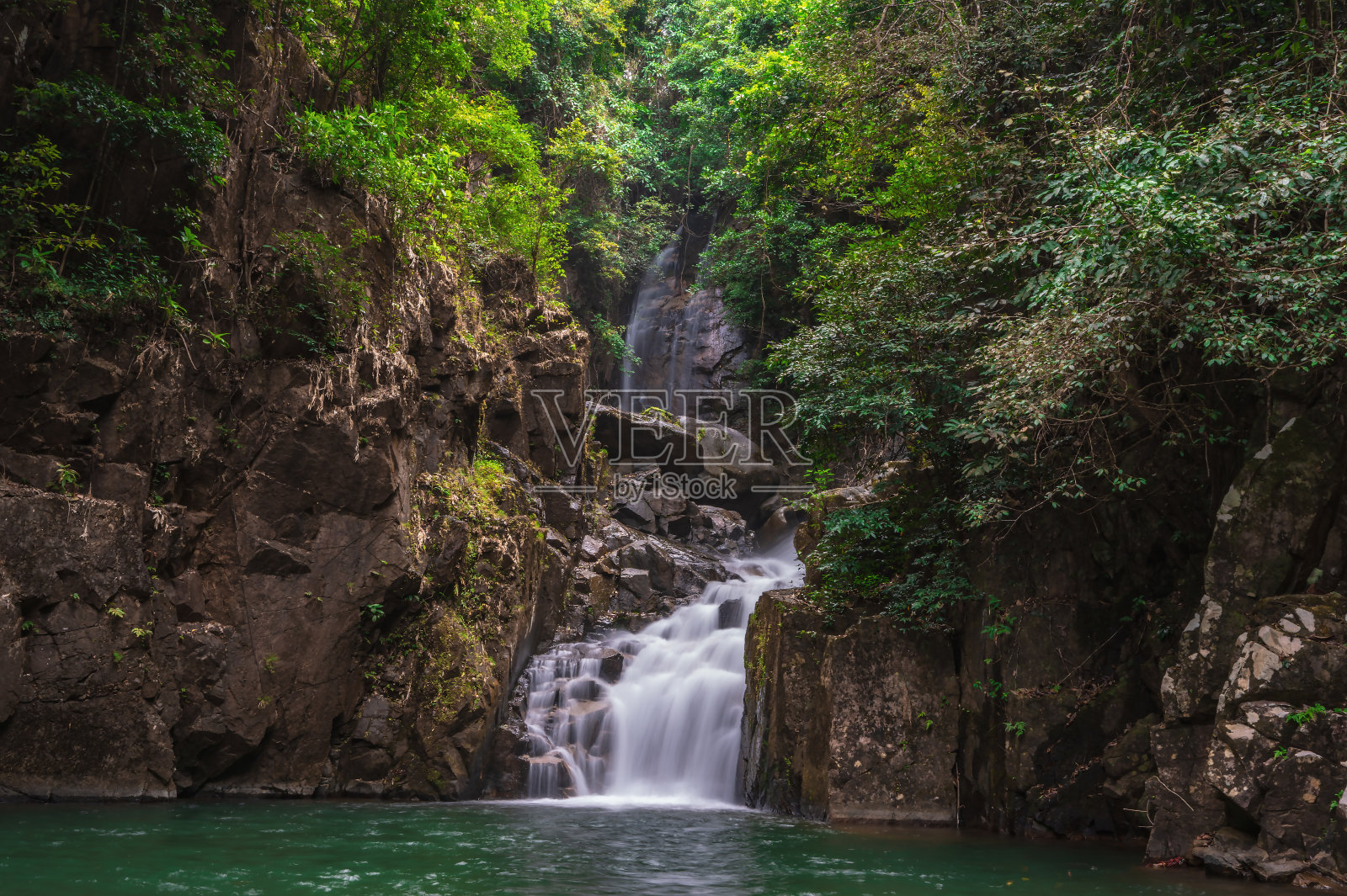 在泰国chanthaburi的namtok phlio国家公园，人们在瀑布中放松。Namtok Phlio国家公园是Chanthaburi省的一个国家公园照片摄影图片