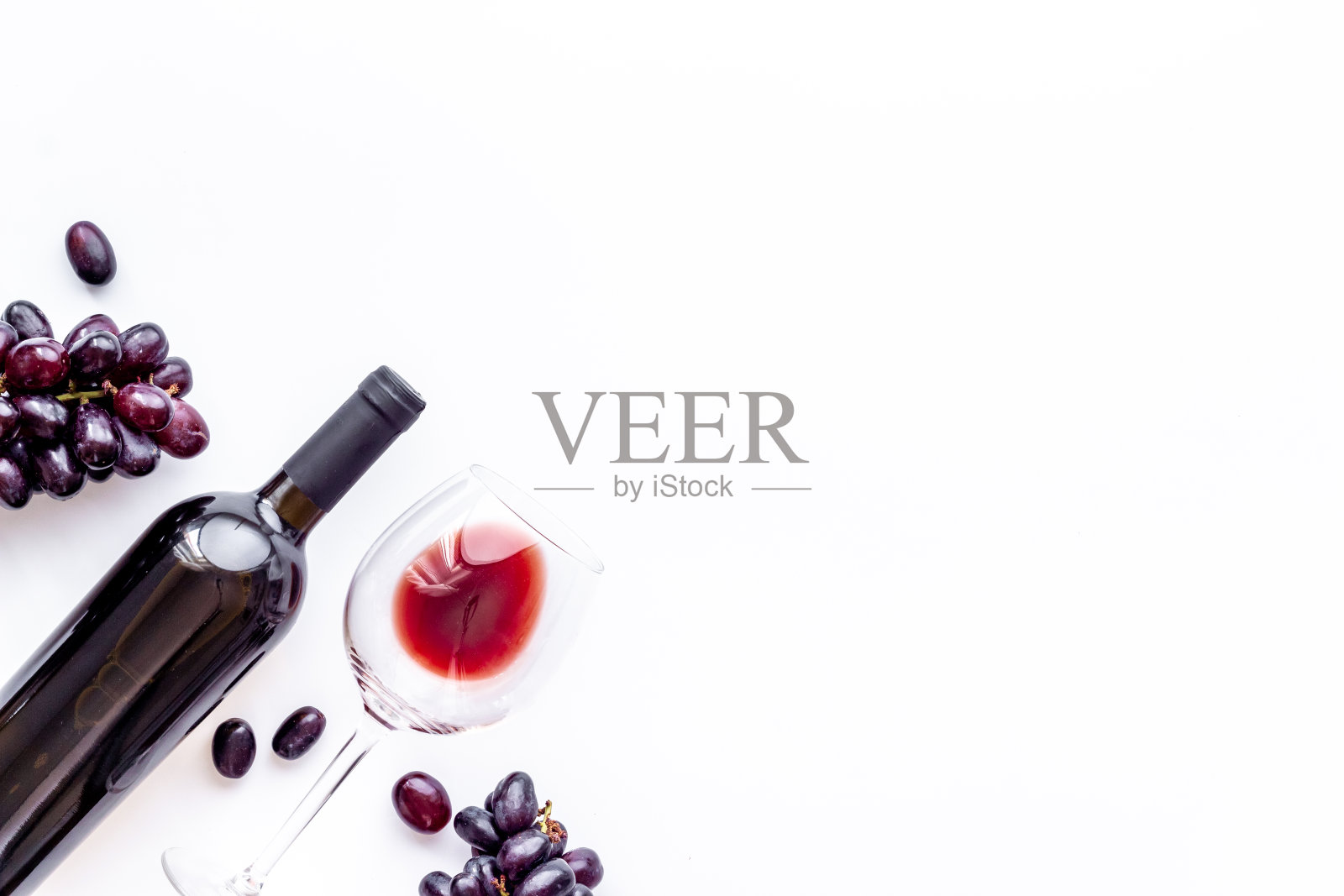 红酒瓶配红酒和葡萄。俯视图照片摄影图片