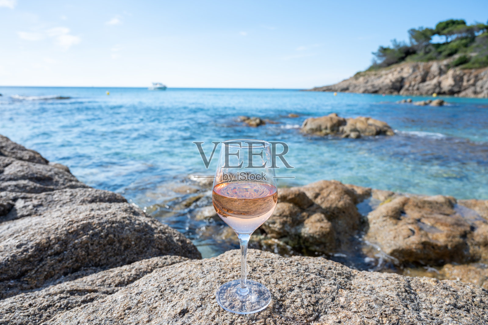 普罗旺斯的夏天，在法国瓦尔省圣特罗佩附近的沙滩和蓝色大海上，一杯冰冷的玫瑰葡萄酒照片摄影图片