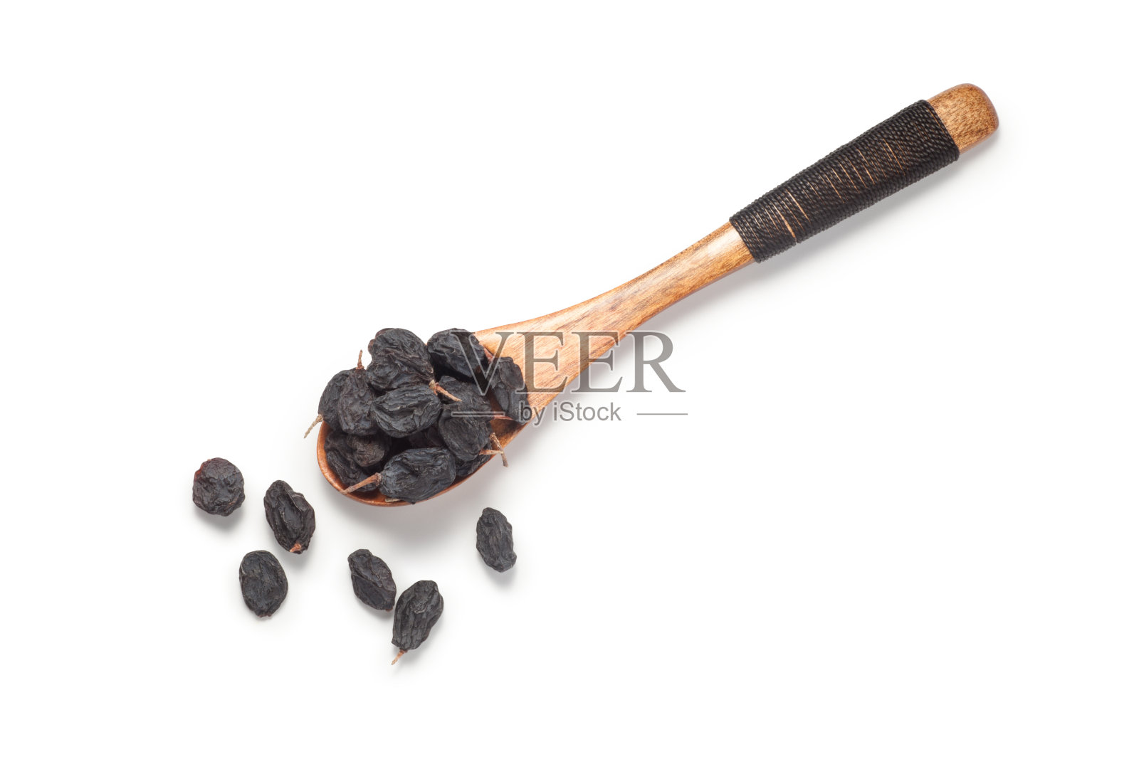 木勺里的黑醋栗葡萄干照片摄影图片