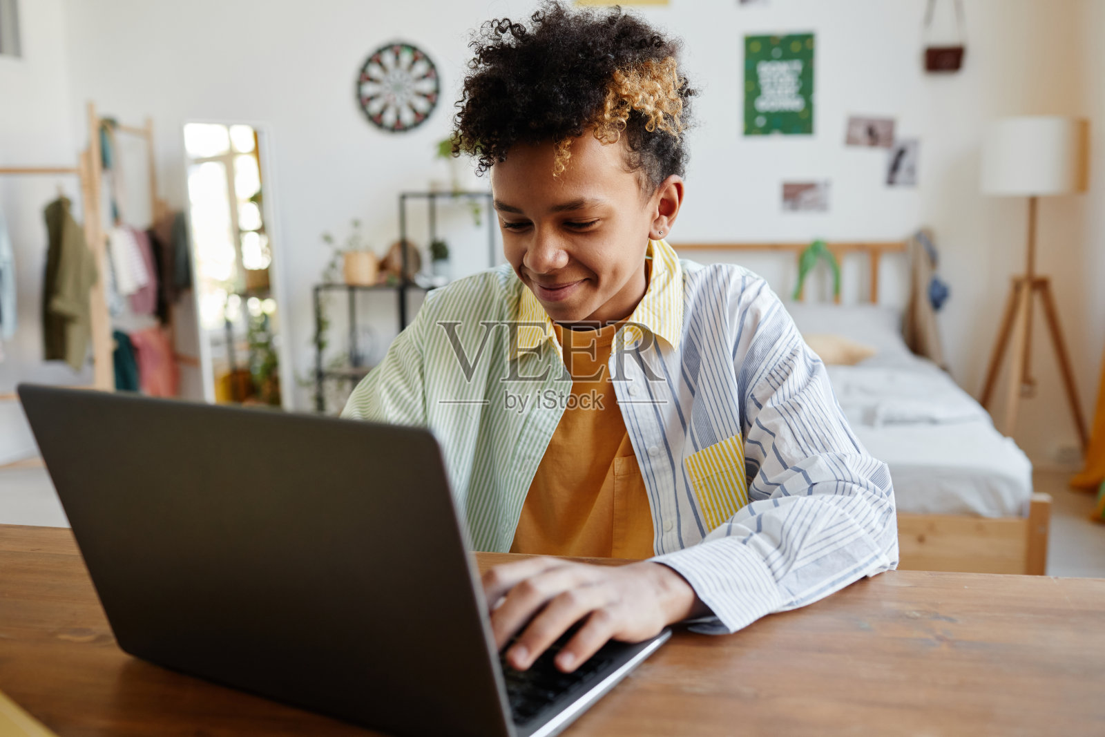 微笑的少年使用笔记本电脑照片摄影图片