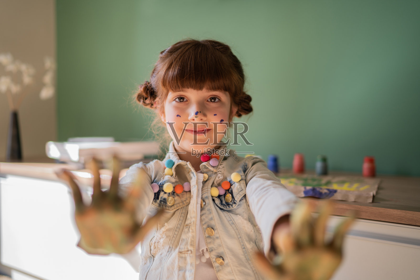 可爱小女孩展示沾满颜料的双手照片摄影图片