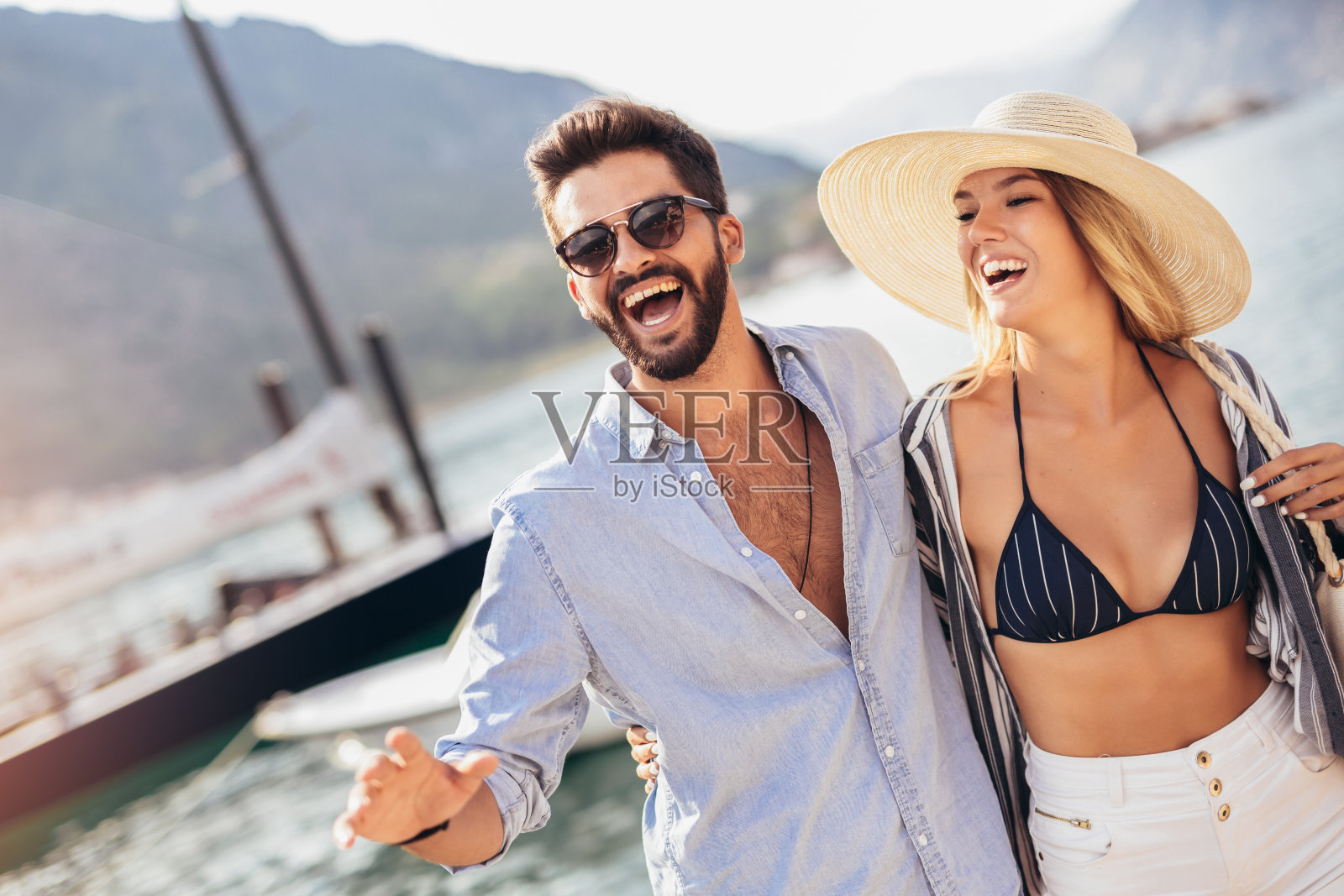 幸福的年轻夫妇在海滩上欢笑和拥抱照片摄影图片