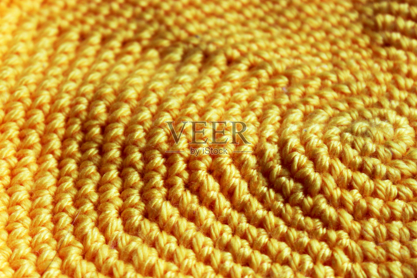 可爱的黄色针织背景，纱线。钩针编织产品特写照片摄影图片