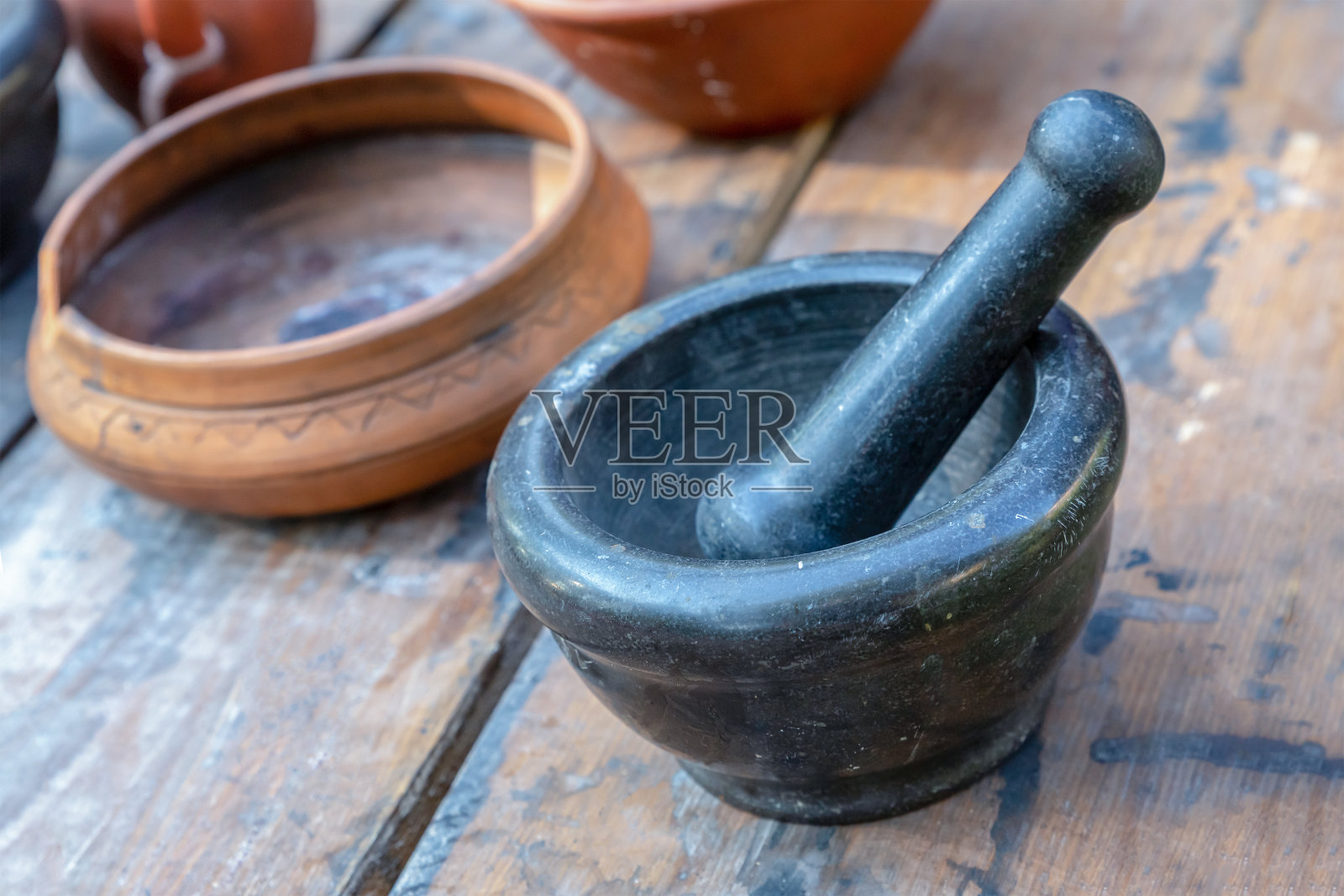 用于研磨的石臼和用于烹饪的泥盘器皿照片摄影图片