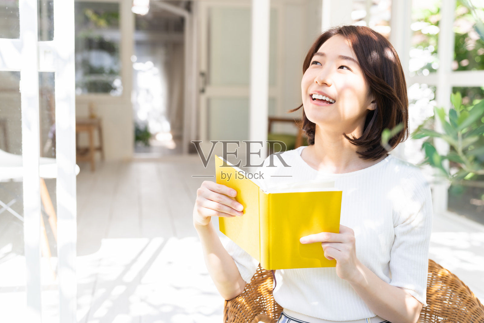 有魅力的亚洲女人读书，花园照片摄影图片