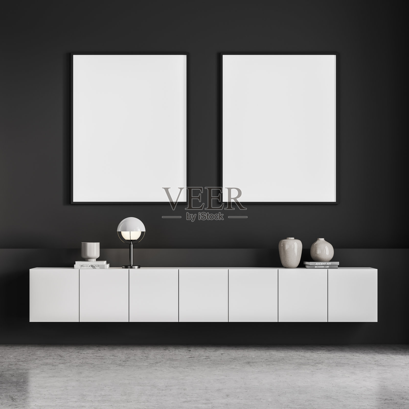 灰色的客厅内部，抽屉柜和两张海报照片摄影图片