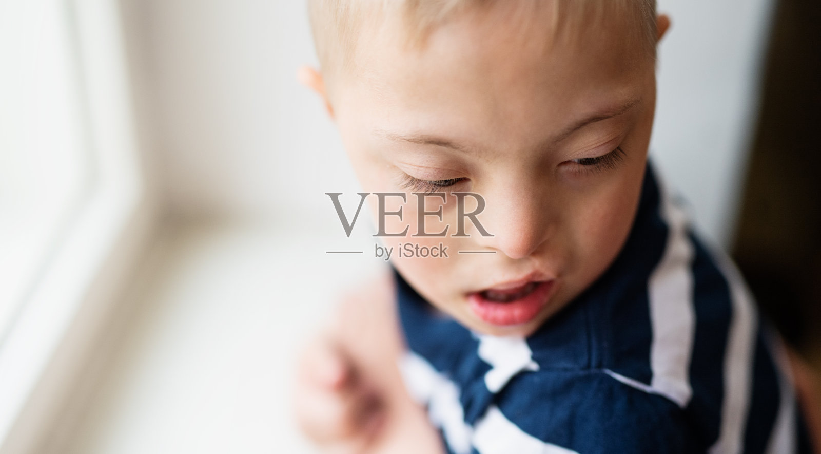 室内唐氏综合征男孩特写肖像，留白照片摄影图片