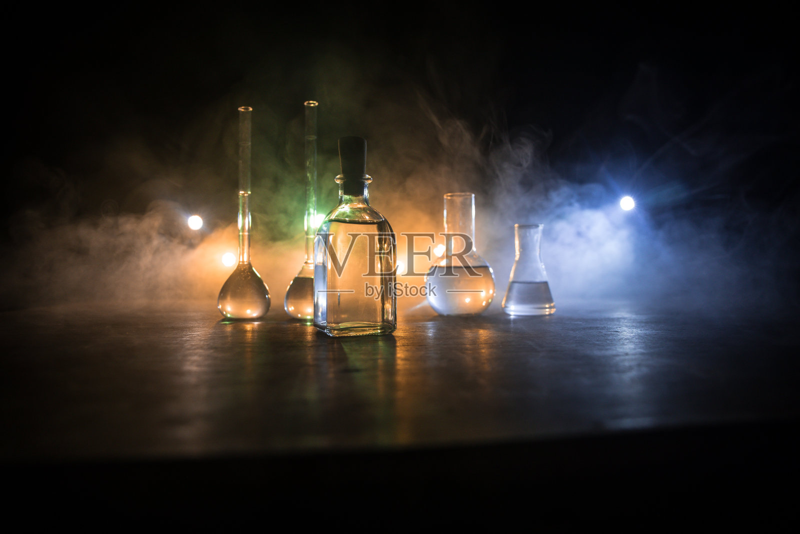 在实验室用溶液测试玻璃烧瓶。科学和医学背景。实验室暗色背景上的试管，科研设备概念照片摄影图片