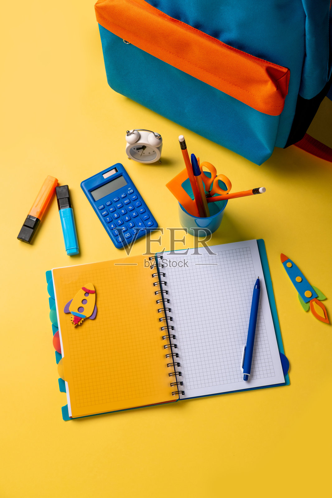 黄色背景上有彩色学习用品的书包。旗帜设计照片摄影图片