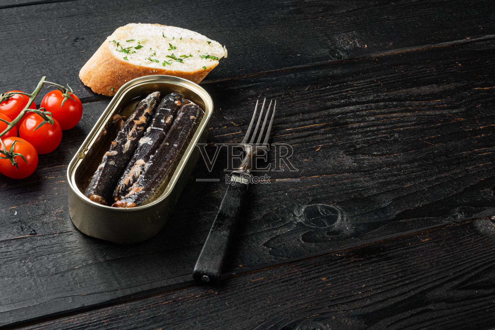铁罐鱼，黑色木桌背景，文本复制空间照片摄影图片