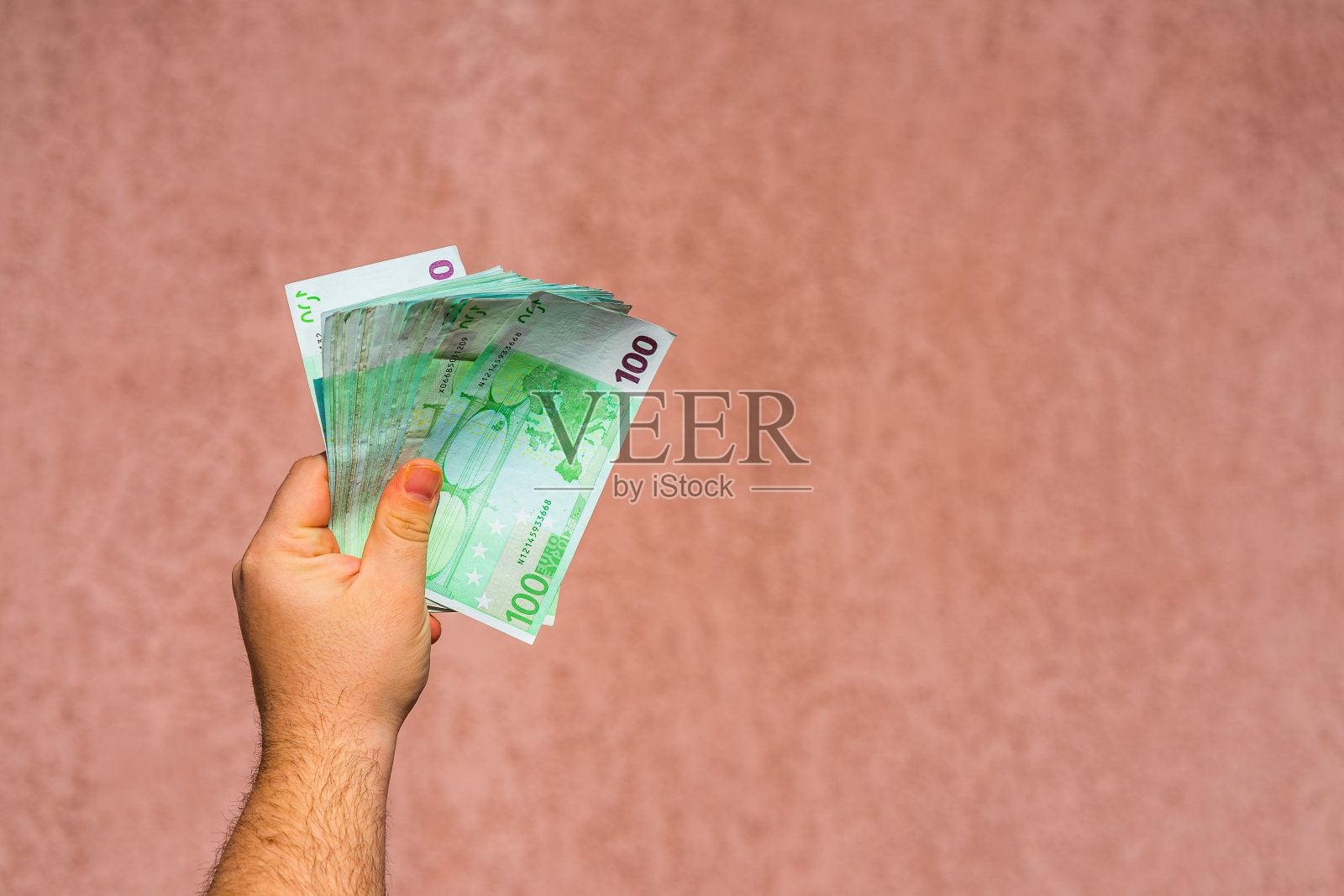 握手并展示欧元或给钱。世界货币概念，100欧元钞票孤立欧元货币。观念富有的商人，存钱还是花钱。照片摄影图片