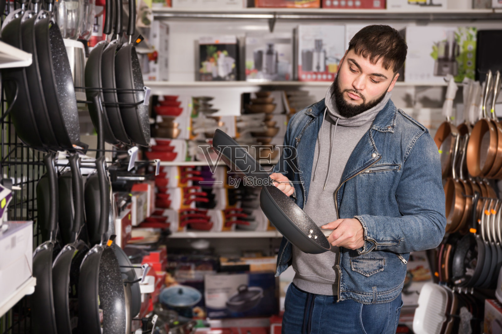 男士在看新的煎锅照片摄影图片