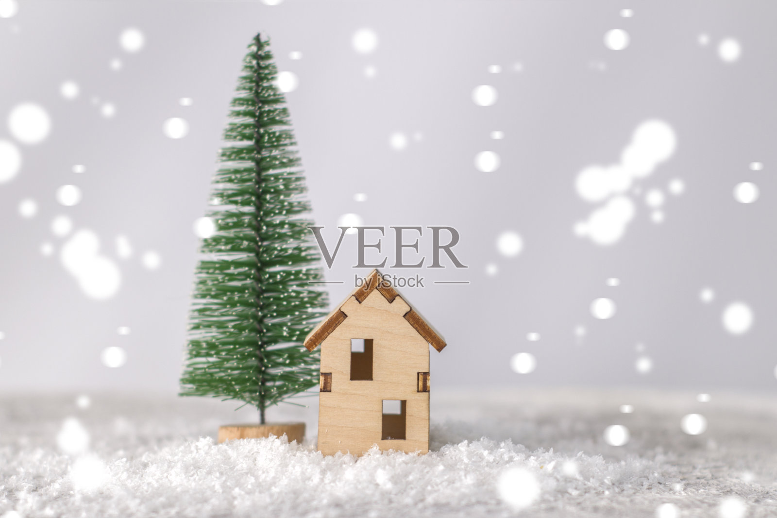 小圣诞树旁的木屋模型照片摄影图片