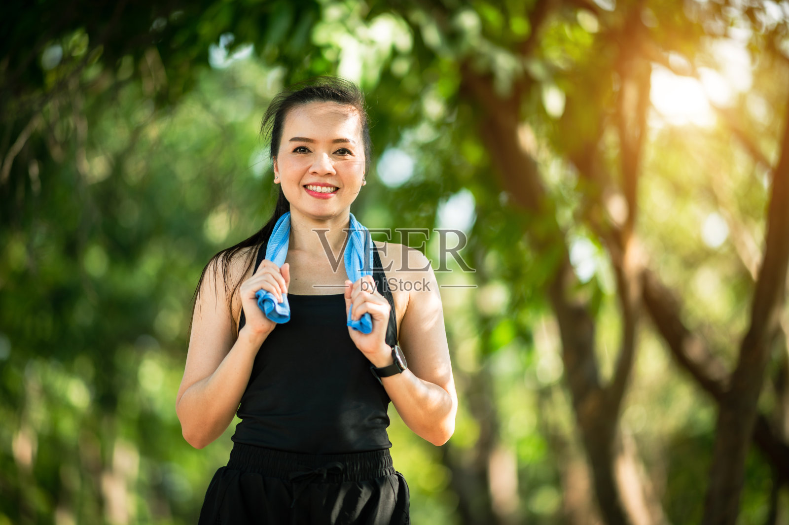 中年美丽的运动亚洲妇女户外散步在公园微笑生活积极和健康的生活方式。照片摄影图片