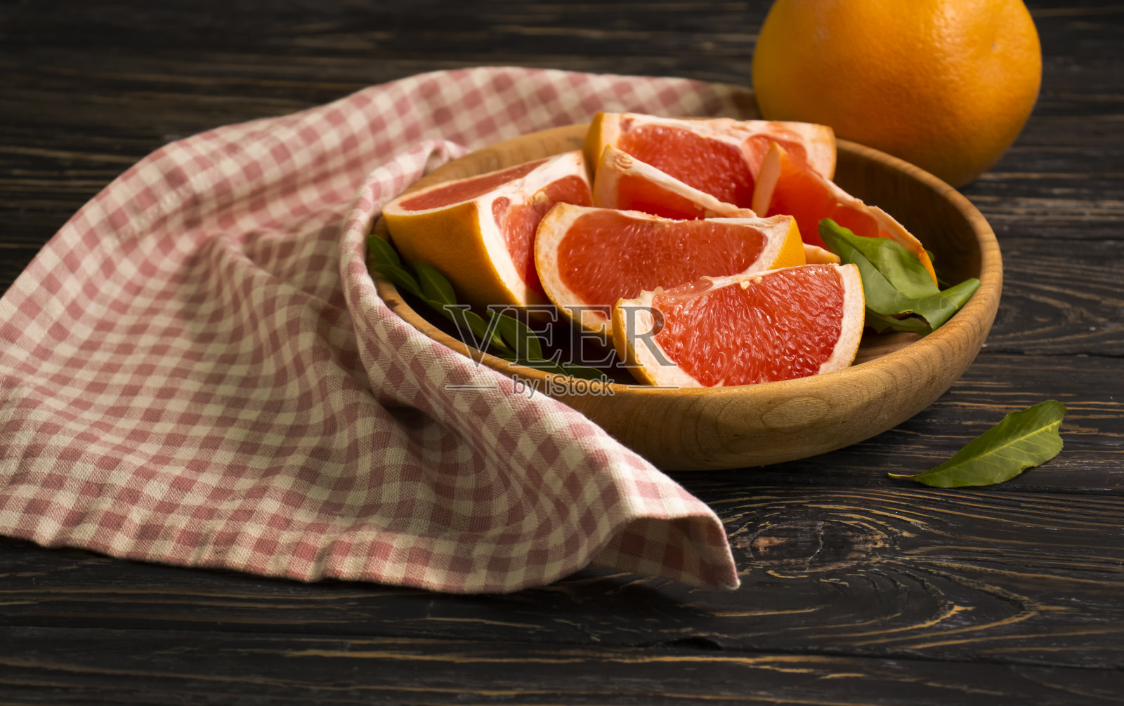 木制背景上新鲜的葡萄柚片照片摄影图片