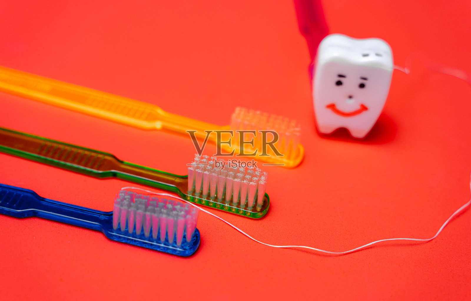 彩色牙刷旁边的玩具笑牙。牙科的概念。裁剪照片照片摄影图片