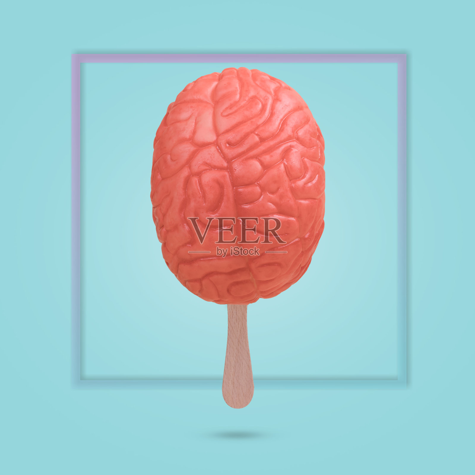 用一根冰淇淋棒和蓝色背景上的人脑做的创意有趣的想法。照片摄影图片