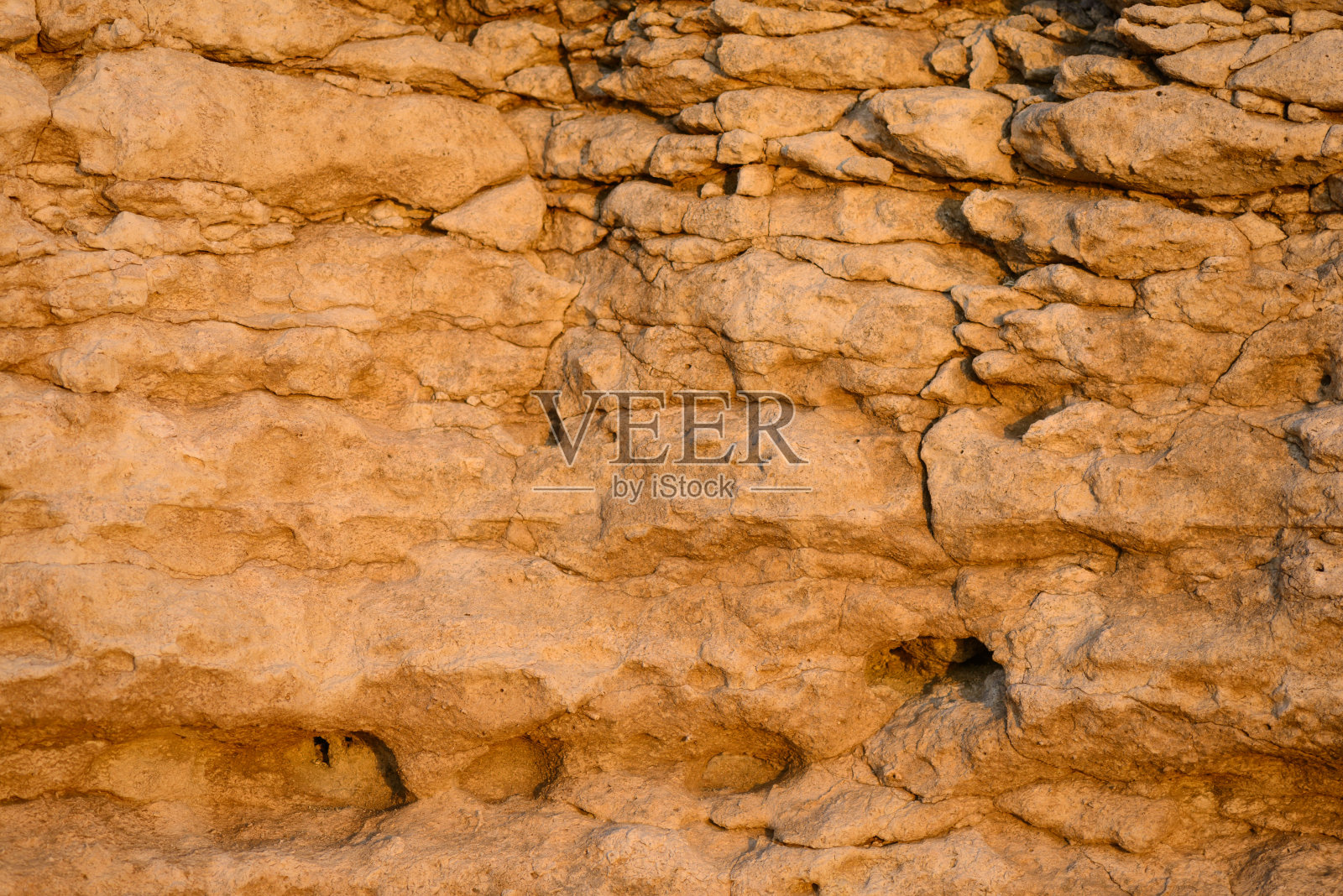 岩石凹凸不平的表面是黄色的照片摄影图片