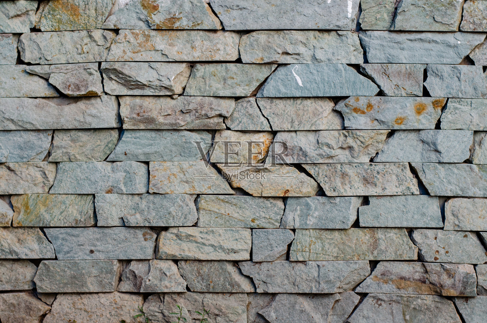 的瓷砖。石头墙。装饰性的岩石。砌筑。照片摄影图片