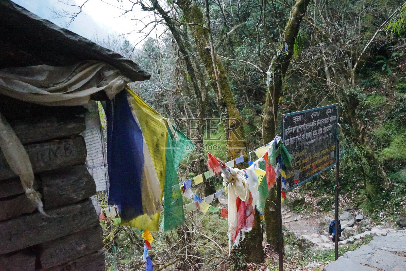 尼泊尔夏尔精神房子之间的雪和岩石悬崖与多云的天空照片摄影图片