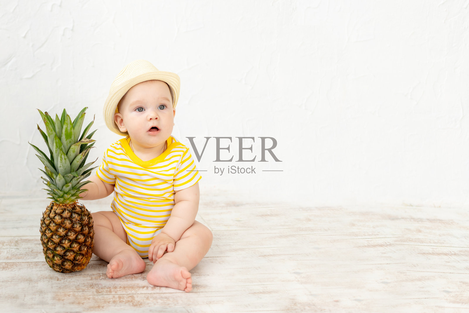 婴儿与菠萝白色背景，旅游和暑假的概念，复制空间照片摄影图片