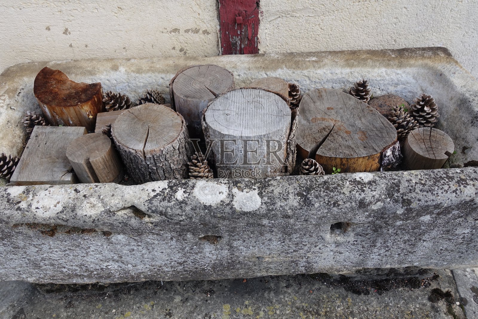 花岗石质花盆，顶部有干原木和松果装饰户外射击照片摄影图片