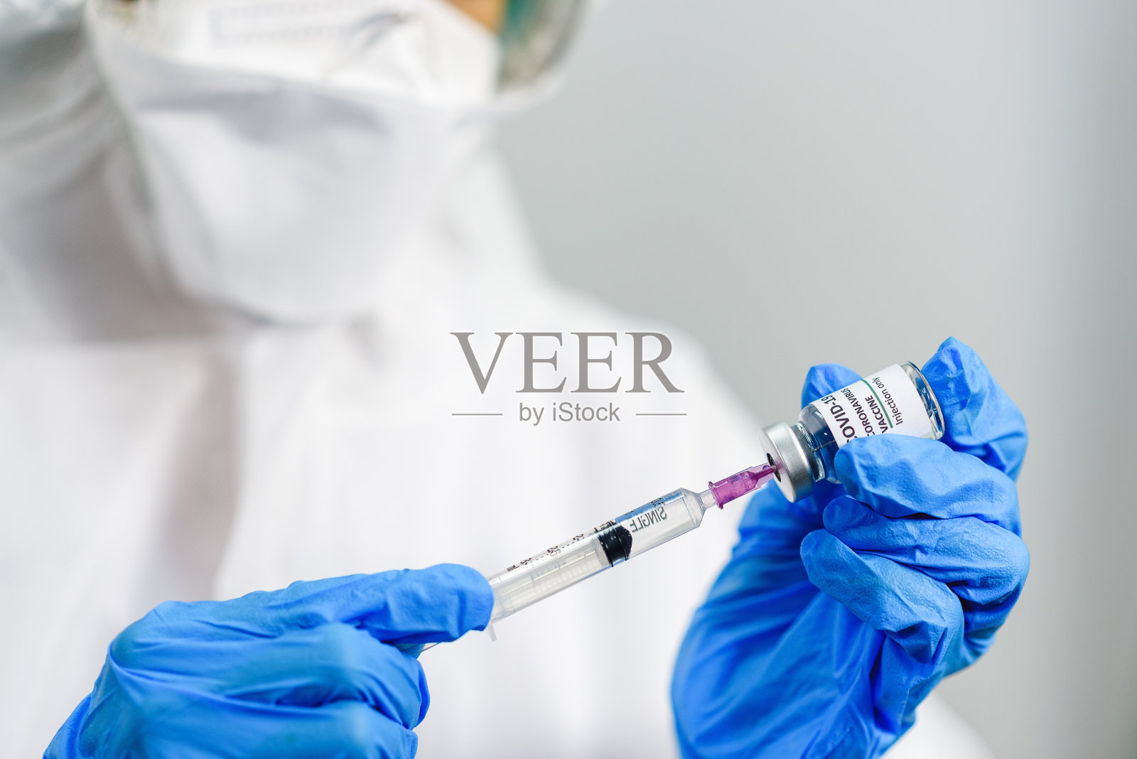 新冠肺炎疫苗小瓶在女医生的手中，并持有注射注射器的新冠肺炎疫苗治疗，冠状病毒治疗，医学和保健概念。选择重点在小瓶..照片摄影图片