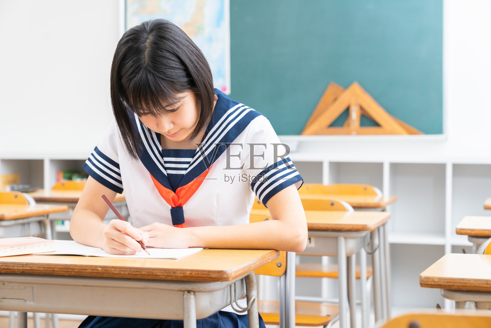 亚洲女学生在教室里学习，穿着校服，照片摄影图片