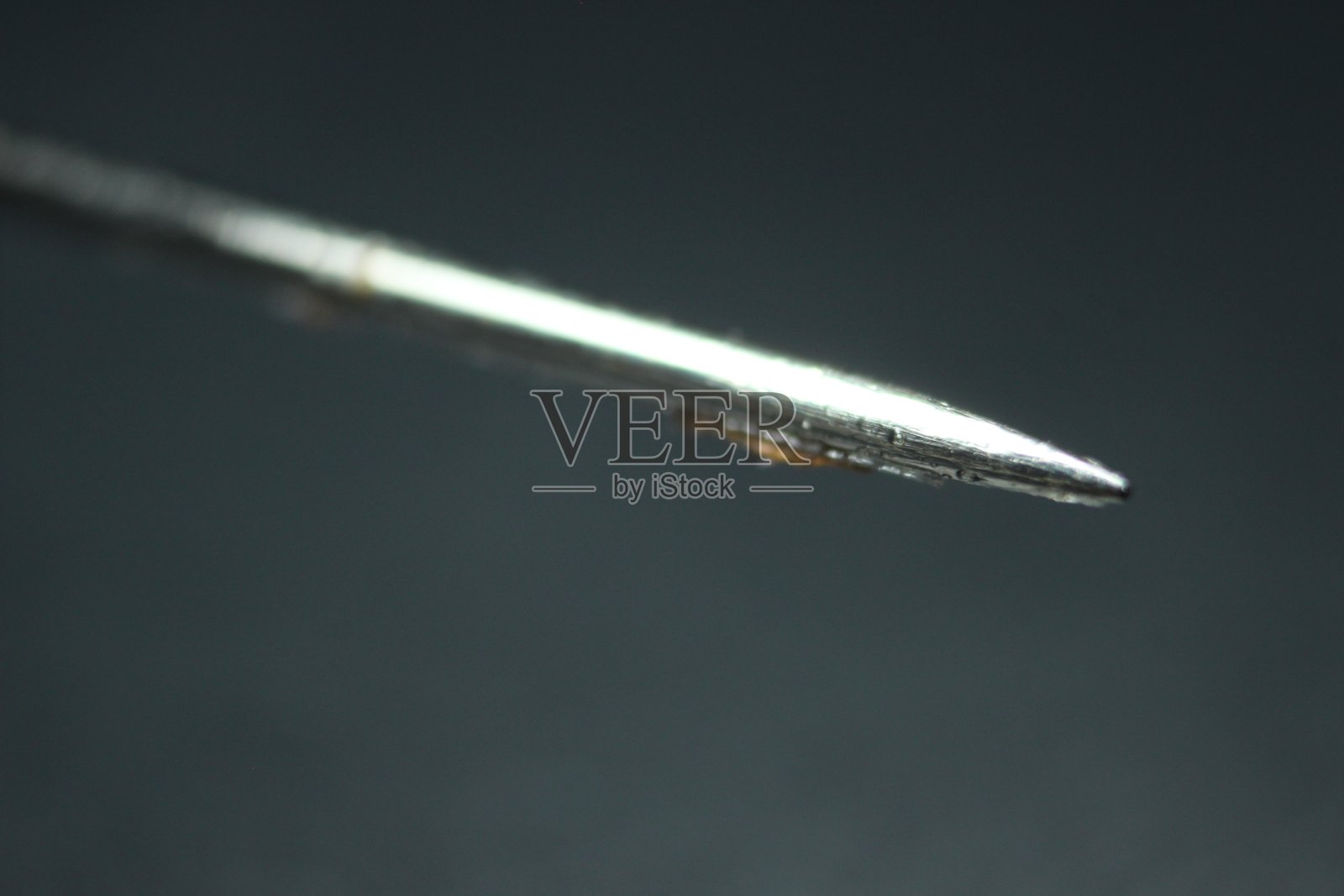 微距照片缝纫针上的黑色背景。照片摄影图片