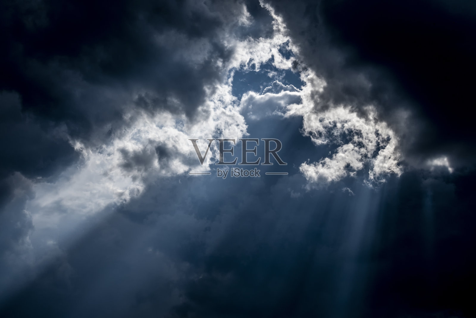 明亮的阳光穿过乌云。照片摄影图片