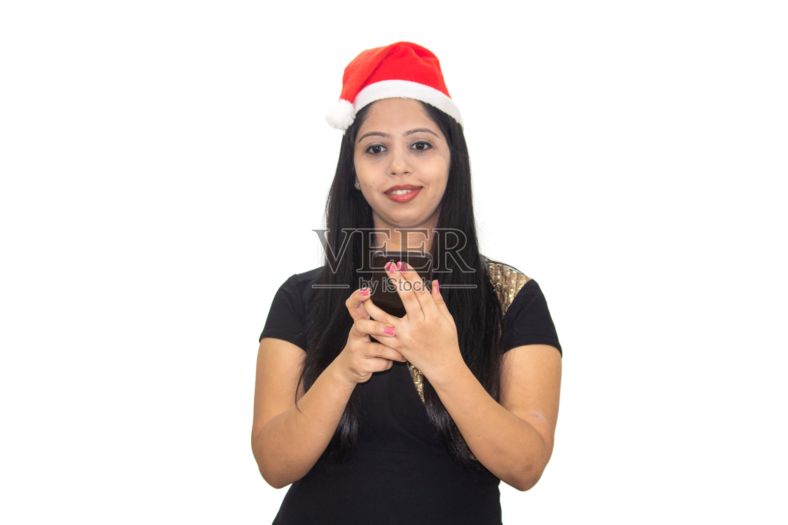 戴着圣诞帽的女人用手机视频聊天照片摄影图片