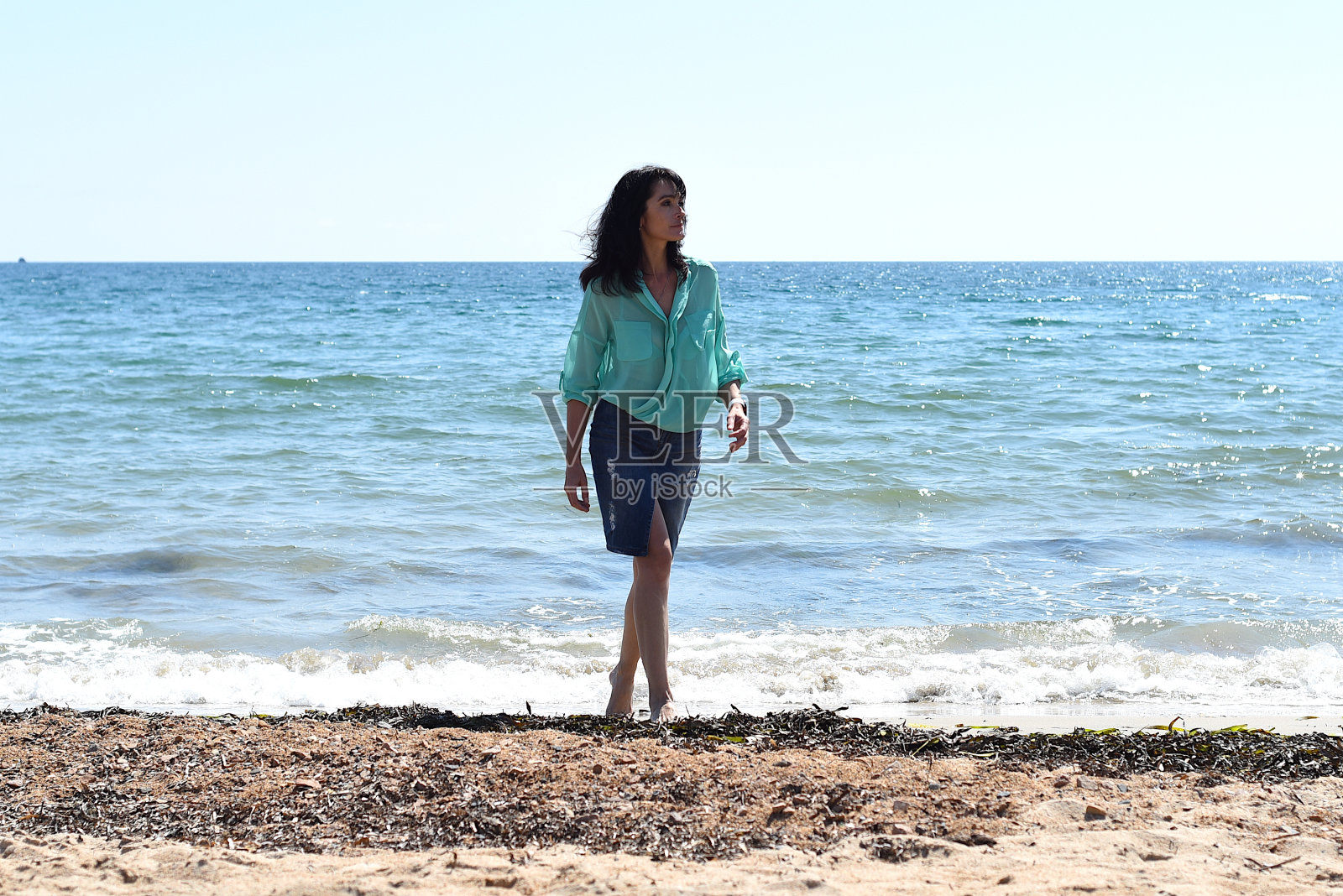 45岁的俄罗斯女人站在日本海，望向别处照片摄影图片